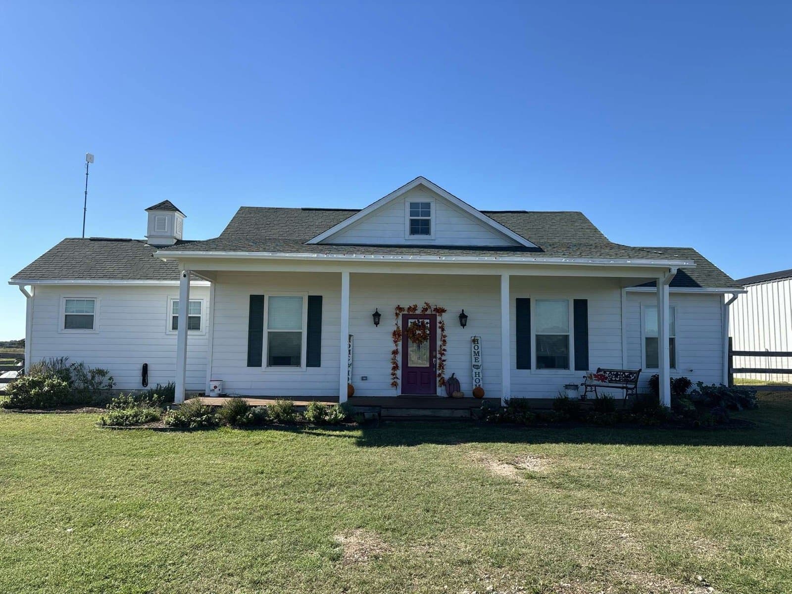 The white farmhouse with its covered porch