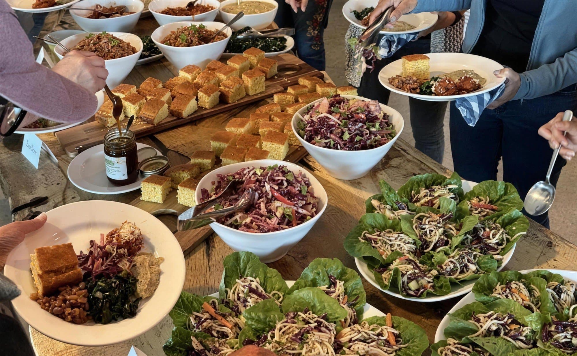 Guests serving up plates from a farm-to-table buffet